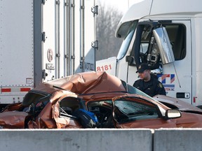 OPP investigate an accident on Highway 401 just east of Prescott on Tuesday. A Quebec trucker was arrested early Tuesday morning hours after two people were killed in a five-vehicle crash late Monday on Highway 401. Four people were also taken to hospital after the crash at about 10:30 p.m. Monday between Prescott and Highway 416, one of them by air ambulance with life-threatening injuries. (TONY CALDWELL/Postmedia Network)