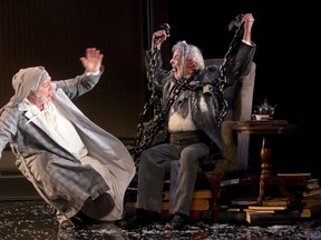 Ebenezer Scrooge, played by Benedict Campbell, is frightened by Jacob Marley (Patrick Monaghan) in A Christmas Carol at the Grand Theatre. (MIKE HENSEN, The London Free Press)