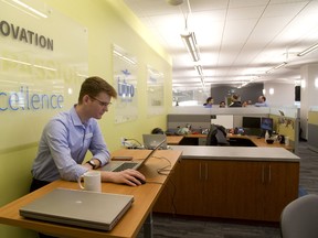 Daniel Abrams of Libro Credit Union works in their new tech area on the 5th floor of their York Street building in London. Libro hosted an open house Tuesday  to announce their intention to compete for young tech sector workers. (MIKE HENSEN, The London Free Press)