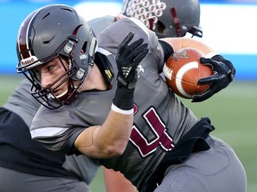 Ethan Martin of London South Collegiate runs the ball against Windsor Holy Names CHS during the Western Bowl at Tim Horton's Field in Hamilton, Ont. on Tuesday November 28, 2017. (Dave Abel/Postmedia Network )