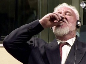 This videograb taken from live footage of the International Criminal Court, shows Croatian former general Slobodan Praljak swallowing what is believed to be poison, during his judgement at the UN war crimes court to protest the upholding of a 20-year jail term. ICTY/AFP/Getty Images