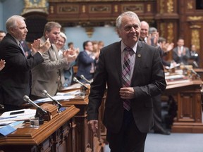 Parti Quebecois MNA Francois Gendron, walks back to his seat as members of the National Assembly applaud for being an elected member for the last 40 years in Quebec City on Tuesday, November 15, 2016. THE CANADIAN PRESS/Jacques Boissinot