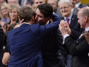 Prime Minister Justin Trudeau hugs Veteran's Affairs Minister Seamus O'Regan after making a formal apology to LGBTQ2 people in Canada, in the House of Commons in Ottawa on November 28, 2017. THE CANADIAN PRESS/Adrian Wyld