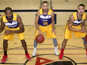 London Lightning's Sefton Barrett, Garrett Williamson and Joel Friesen-Latty show off the jerseys they will be wearing in honour of Shine the Light on Woman Abuse at their game Thursday in London, Ont. (MIKE HENSEN, The London Free Press)