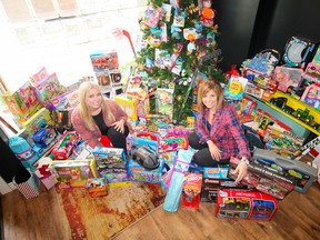 Melody Hodgson and Brenda Campbell from Realty Executives Platinum Limited pose in front of the Christmas tree. (Submitted photo)