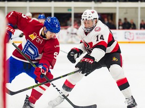 Belleville Senators forward Jim O'Brien ties up Laval Rocket defenceman Tom Parisi during AHL action Wednesday night at Yardmen Arena. (Ottawa Senators photo)