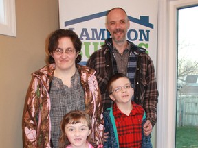 The Robinson family celebrate in their new home following a key ceremony organized by Habitat for Humanity Sarnia-Lambton on Tuesday. Celebrating are mother Jocelyn, father Bruce, five-year-old Lilly and 10-year-old Erik. (Carl Hnatyshyn/Postmedia Network)