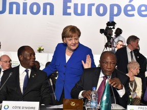 German Chancellor Angela Merkel (C) arrives to greet Ivory Coast's President Alassane Ouattara (L) and Guinea's President and African Union (AU) chairman Alpha Conde during the 5th African Union - European Union (AU-EU) summit in Abidjan, on November 29, 2017.
Ivory Coast President opened a Europe-Africa summit on November 29, calling for "all urgent measures" to end migrant abuses, including slave trading in Libya. ISSOUF SANOGOISSOUF SANOGO/AFP/Getty Images