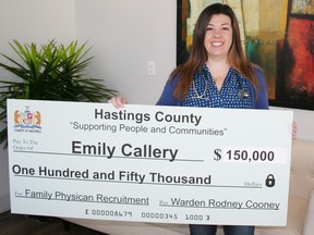 John Nicholas/Hastings County
Dr. Emily Callery holds her cheque after signing a deal with Hastings County. She'll receive a total of $150,000 for at least five years of practising family medicine in Marmora and emergency shifts at North Hastings Hospital in Bancroft.