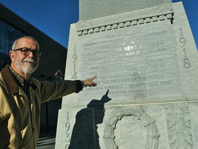 Jerry Hind points to section of the Chatham cenotaph which appears to have dark markings around the lettering Nov. 28. The cenotaph underwent a restoration and cleaning which finished in November 2016 and Hind says he noticed the markings the following summer.