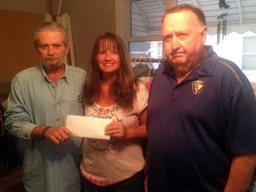 Knights of Pythias members Bob Micks, left, and Charlie Masefield, right, accept a donation of $96.55 from Melody, to go towards last week's Breakfast with Santa held at the Knights of Pythias hall. Melody raises money thorough regular yard sales she hosts. She then takes that money and donates it to worthy causes.