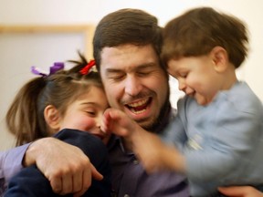 In this 2004 photo, Maher Arar, who was wrongly imprisoned and tortured in Syria based on inaccurate Canadian intelligence, plays with his children Baraa, then 7, and Houd, 2, in his home in Ottawa. Baraa Arar, now 20, has stepped out as a role model for young women and young Muslims. (Photo by Bill Grimshaw/Getty Images)