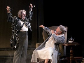 Ebenezer Scrooge, played by Benedict Campbell, is frightened by Jacob Marley (Patrick Monaghan) in A Christmas Carol at the Grand Theatre. (MIKE HENSEN, The London Free Press)