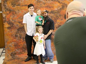 Tim Miller/The Intelligencer
Photographer Brad Denoon lines up a photograph of the Derby family (Deejay Derby with children Dustin, DJ and Daisy) at a Help Portrait photoshoot at Bridge Street United Church on Saturday.