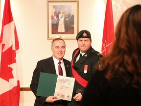 Tim Miller/The Intelligencer
Bay of Quinte MP Neil Ellis (left) stands for a photo with Sgt. Stephen Barkema of the Hastings and Prince Edward Regiment at a Bay of Quinte Commemorative Coin presentation ceremony on Sunday in Belleville.