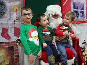 Sporting Christmas-themed shirts, Lucas Thompson, 6, and his brothers, Wesley, 2, and Nolan, 4, of Tillsonburg were among those who had a chat with Santa Claus during the Kinette Club of Tillsonburg's 10th annual Breakfast with Santa fundraiser at the Tillsonburg Community Centre on Saturday, Dec. 2. JOHN TAPLEY/FOR THE TILLSONBURG NEWS