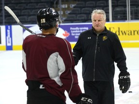 London Knights coach Dale Hunter works with forward Cole Tymkin at practice at Budweiser Gardens last week. Hunter, who chalked up his 700th win as coach Saturday, has had a big impact on the game, says OHL commissioner David Branch. (MORRIS LAMONT/THE LONDON FREE PRESS)