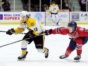 Sarnia Sting's Brady Hinz, left, is chased by Oshawa Generals' Kyle MacLean in the first period at Progressive Auto Sales Arena in Sarnia, Ont., on Sunday, Dec. 3, 2017. (Mark Malone/Postmedia Network)