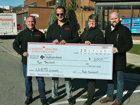 Canadian Executive Search Group Inc. corporate client manager Chris Couture and president Kyle Pinsonneault present a $2,000 cheque to Chatham-Kent Gay Pride Association president Marianne Willson and Chatham Coun. Brock McGregor at the corner of King Street West and Second Street in Chatham Friday. The funds cover the municipal share of an $8,000 project to install rainbow crosswalks in the area.