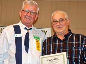 Auston Hayward (left), South Western Ontario Square Dancing Association (SWOSDA) representative, presented Greg Luyten, of the Rostock area, a merit award to his late wife Helma, during the SWOSDA dance held Nov. 25 at the Crystal Palace in Mitchell. ANDY BADER/MITCHELL ADVOCATE