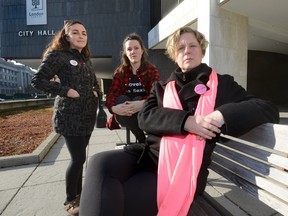 Julie Baumann, of SafeSpace, AnnaLise Trudel, of Anova, and Jodi Hall, of Fanshawe College, l-r, at London's City Hall where they are pushing to remove the no touch rule from the bylaws governing strips clubs and body rub parlours. (MORRIS LAMONT/THE LONDON FREE PRESS)