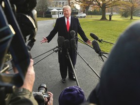 President Donald Trump speaks to reporters on the South Lawn of the White House in Washington, Monday, Dec. 4, 2017. (AP Photo/Susan Walsh)