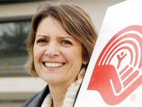 Luke Hendry/The Intelligencer 
Melanie Cressman of the United Way Hastings and Prince Edward holds the charity's logo outside the Belleville office Monday. The charity has raised more than $1.1 million since September — but needs more than $800,000 this month to meet its $1.97-million goal.