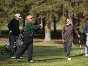 Clay Charlong tees off as Ron Boudreau, left, Rick Monfort and Randy Marshall watch during a round Monday at East Park in London. Golfing in December is rarely as comfortable as it has been lately. Charlong and Marshall, who are No. 1 and 2 in the club championships, say they play seven days a week when possible. East Park employee Tara Berry said the warm weather made last week ?super busy. On Tuesday, we had every tee time booked.? (MIKE HENSEN, The London Free Press)