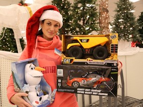 Michelle Lafortune, a parent resource worker for Our Children, Our Future, holds a selection of toys donated to a Christmas toy drive in support of the organization at the New Sudbury Canadian Tire location in Sudbury, Ont. on Thursday December 8, 2016. John Lappa/Sudbury Star/Postmedia Network