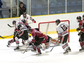 Sarnia Legionnaires Jon Sanderson (No. 10 in white) and Brock Perry (No. 20) swarm to the attack during the club's last home game. Behind the net is Sarnian Greg Hay. The Legionnaires return to action Thursday when they host the LaSalle Vipers. (Photo courtesy of Shawana Lavoie)