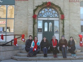 Huron County Health Unit representatives were up bright and early last Friday morning to tie hand-knitted red scarves along Albert Street in Clinton as part of the Red Scarf Project for HIV/AIDS awareness. The group, some of them donning their own red scarves, posed for a photo at Town Hall after all the scarves were hung. From left: Michelle Carter, Annie Odette, Darlene Staschuk, Shelley Spencer, Kate Underwood, Rhonda Howatt. (SHEILA PRITCHARD/CLINTON NEWS RECORD)