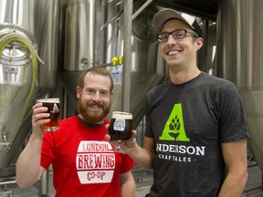 Gavin Anderson of Anderson Craft Ales, wears a London Brewing Co-op and Aaron Lawrence of London Brewing Co-op wears an Anderson Craft Ales shirt in honour of their cross pollination of beers being brewed in London, Ont. (MIKE HENSEN, The London Free Press)