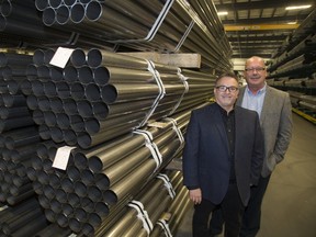 Joe Serratore, left, regional director for Windsor-based Power Factor Max, helps manufacturers like David Inman, director of manufacturing at London?s CS Automotive Tubing Inc., save on their hydro bills. Inman says Power Factor Max technology has dramatically reduced its energy costs.  (Derek Ruttan/The London Free Press)