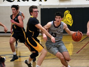 Frontenac Falcons Connor Vreeken drives to the net past LaSalle Black Knights Landon Elliot, left, and Hughsten Coleman during senior boys basketball action at LaSalle Secondary School in Kingston on Tuesday December 5 2017. Ian MacAlpine /The Whig-Standard/Postmedia Network