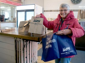 Meals on Wheels London volunteer Anne Baverstock prepares a meal for delivery at The Village Table on Dundas Street.  (CHRIS MONTANINI, Londoner)