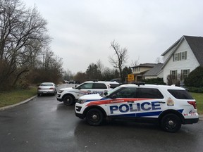Kingston Plice vehicles block access to Graceland Avenue in Kingston, Ont. on Tuesday, Dec. 5, 2017. Police were called to the area after reports of a man with a gun inside. When police entered they found an elderly woman dead and the elderly man with critical injuries. The man died later in hospital. 
Elliot Ferguson/The Whig-Standard/Postmedia Network