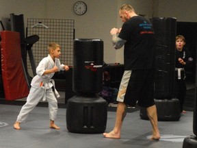 Co-founder of Bowen Brazilian Jiu Jitsu James Murray, right, guides Alexander Ainscow through a routine at his downtown St. Thomas gym. Ainscow is one of more than 70 children enrolled in the gym's shin atemi program, still only four years old. (Louis Pin // Times-Journal)