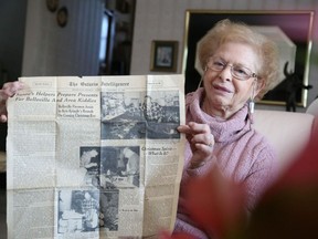 Jason Miller/The Intelligencer 
Helen Kelly holds a Dec. 13 1958 edition of The Ontario Intelligencer which featured a full page spread with articles and photos detailing the toy repair operation founded by her father in Belleville.