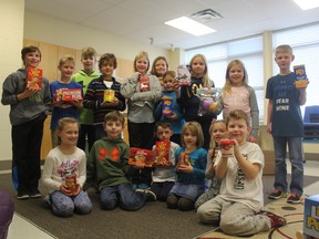 Students at Pierre Elliott Trudeau French immersion school sponsored 12 families through the Christmas Care program. They collected food, toys and other items to donate to families in need. (Laura Broadley/Times-Journal)