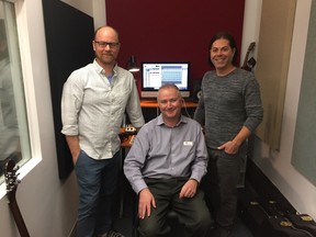 Aaron Holmberg and Chris O’Connor, who were behind the fundraising album Christmas is for Boys and Girls, flank Harold Parsons, executive director of the Boys and Girls Club of Kingston and Area, inside the control room of the club’s new recording studio on Tuesday. (Peter Hendra/The Whig-Standard)