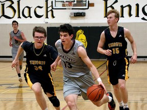 Frontenac Falcons' Connor Vreeken drives to the net past LaSalle Black Knights Landon Elliot, left, and Hughsten Coleman during senior boys basketball action at La Salle Secondary School in Kingston on Tuesday. (Ian MacAlpine /The Whig-Standard)