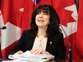 Ontario auditor general Bonnie Lysyk packs her the pages of her annual report as she prepares to leave a news conference in Toronto, Wednesday, Dec.6, 2017. THE CANADIAN PRESS/Frank Gunn ORG XMIT: FNG506