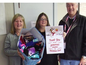 Cathy Hiscox, left, and Edith Smith, Times-Journal multi-media ad sales, present T-J reader Christmas Care donations to Carl Bagshaw, Christmas Care co-ordinator. (Eric Bunnell/Times-Journal)