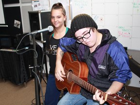 Rachael Spiece and Jess Anthony are shown in this file photo preparing for Open Mike Night at Sarnia Lambton Rebound's r.LOUNGE. The popularity of open mike nights has led Rebound to launch a new music program for youth. (File photo)