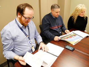 Luke Hendry/The Intelligencer
Hastings County's assistant manager of housing services, Matt Carty, manager Darren Burke and community and human services director review Geertsma Homes Ltd.'s proposal for the Home for Good project Thursday in Belleville. It was the only submission for the county's request for proposals.