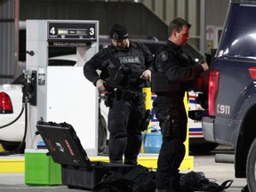 Tactical officers from Waterloo regional police pack up their equipment Friday about 12:15 a.m. after assisting London police in dealing with a distressed officer inside London headquarters Thursday. (DALE CARRUTHERS, The London Free Press)