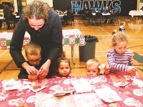 Camellia Nelson, makes crafts with her son, Liam, 4, niece Mary Watters, 2, son Porter, 1, and niece Elva Watters, 5.