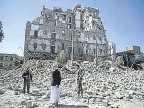 Houthi Shiite rebels inspect the rubble of the Republican Palace that was destroyed by Saudi-led airstrikes, in Sanaa, Yemen, on Wednesday. Former president Ali Abdullah Saleh was killed on Monday by his onetime allies, the Iran-backed Houthis. Sanaa has witnessed heavy fighting since last week between Saleh?s loyalists and Houthis, forcing many Yemenis to cower indoors fearing the violent street clashes. (Hani Mohammed /AP Photo)