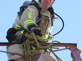 Ian Van Reenen hoists a 45-pound bundle up six flights of stairs while practicing at Lambton College in this 2013 file photo. The Oakville firefighter was part of two new world records at the recent Scott Firefighter Combat Challenge in Kentucky. (Observer file photo)