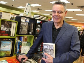 Daniel Schwanz, aka Daniel Barton, poses with a copy of his book "Watch" at The Book Keeper in Sarnia. The Petrolia man self-published the novel in November. Tyler Kula/Sarnia Observer/Postmedia Network